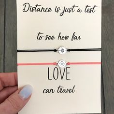 someone is holding two bracelets that say distance is just a text to see how far love can travel