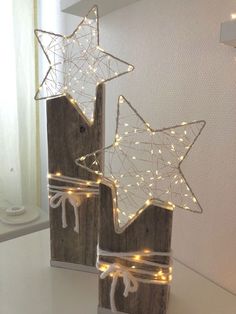 two wooden boxes with lights in them on a table