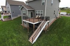 an aerial view of a house with stairs leading up to the upper level and second story