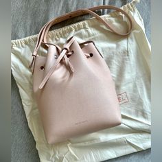 Excellent Condition And Not Worn Many Times. Mansur Gavriel Mini Bucket Bag In Saffiano Pink Leather. Minor Signs Of Wear Included In Pictures Width : 7 In / 18 Cm Height : 9.8 In / 25 Cm Depth : 4.75 In / 12 Cm Crossbody Drop: Max 24.5in / 62.2 Cm - Min 17.5in / 44.5cm Composition: Saffiano Leather Made In Italy From Ms Website: The Mini Version Of Our Signature Bucket Bag Is Slightly More Compact, But With The Same Distinctive Look And Feel. Sourced From A Family-Owned Tannery In Italy, It Is Made From High Quality Saffiano Leather Which Is Coated And Textured In A Cross-Hatched Pattern On Its Surface. Pink Saffiano Leather Formal Shoulder Bag, Formal Pink Saffiano Leather Shoulder Bag, Elegant Pink Pouch Bucket Bag, Everyday Saffiano Leather Shoulder Bag With Dust Bag, Elegant Pink Bucket Bag For Daily Use, Elegant Pink Bucket Bag For Travel, Formal Pink Crossbody Bucket Bag, Pink Formal Bucket Shoulder Bag, Elegant Pink Bucket Bag For Formal Occasions