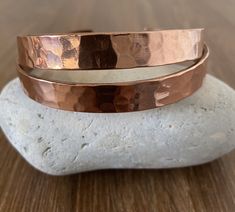 These hammered copper bracelets are handmade with solid/pure copper  Includes a jewellery polishing cloth. Size: 1 Length -18-19cm appox - As It's open-ended, would fit most hands Width - 10mm Weight - 25 gm approx Size:  Length -19-20cm appox - As It's open-ended, would fit most hands Width - 10mm Weight - 35 gm approx To fit the bracelet open it up so the gap is wide enough to pass over the narrowest part of your wrist and then squeeze it back into shape until it is a nice comfortable fit. Ben Gift Double Band Cuff Bracelet, Adjustable Double Band Cuff Bracelet As Gift, Handmade Double Band Bracelet As Gift, Adjustable Round Copper Cuff Bracelet, Adjustable Copper Cuff Bracelet, Handmade Adjustable Double Band Bracelets, Hammered Cuff Bracelet, Copper Bracelets, Copper Cuff Bracelet