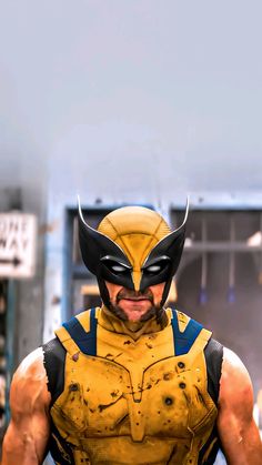 a man dressed as wolverine stands in the street