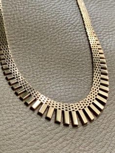 RADIANT! 14k Gold Cleopatra Link Necklace - Vintage Danish - 17 inch length Aaaahhh! A silky textile of gold bricks. Am I dreaming?? Danish made, high polish, 14 karat gold cleopatra link necklace in a great length of 17 inches. Fringe necklace is graduated in width from 6.6mm to 18.2mm in the center and weighs an excellent 42.77g. A phenomenal example of a Danish link necklace with cleopatra fringe. This style was popular in the 1960s. Piece is in excellent condition with normal age related wear.  I love the wider width of this one - lush gold fringe yum! A stunning piece you'll receive countless compliments on. Details  * Maker JTH  * Tage Hansens Guldsmedie  * Nyrup, Denmark  * Active from 1965  * 17 inch length  * 6.6 - 18.2mm width  * 14k solid gold (not plated or fill)  * 42.77g  * H Luxury Gold Rectangular Necklace, Gold Art Deco Necklace For Formal Occasions, Art Deco Gold Necklace For Formal Occasion, Gold Bricks, Gold Cleopatra, Vintage Gold Necklace, Am I Dreaming, Wedding Necklace Set, Gold Fringe