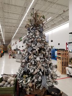 a decorated christmas tree in the middle of a store