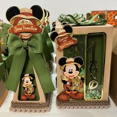 two boxes that have some kind of mickey mouse on them, one is green and the other is brown