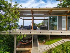 the house is surrounded by trees and has stairs leading up to it's roof