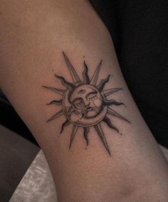 a sun and moon tattoo on the arm