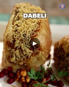 an image of food on a plate with the words dabeli in front of it