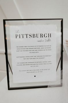 there is a sign on the table that says pittsburgh, and it's written in black ink