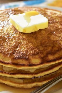 a stack of pancakes with butter on top