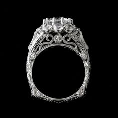 an antique style diamond ring on a black background