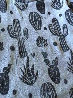 a t - shirt with black and white cactus designs on it