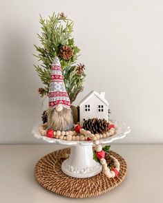 a gnome on a cake plate with pine cones