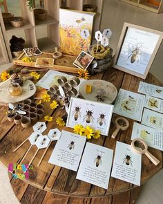 several cards and pictures on a table with flowers, bees and beehives