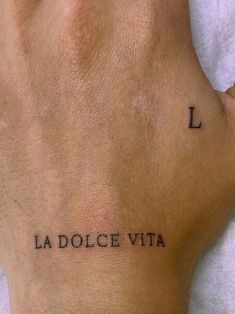 a person's foot with the word la dolce vita tattooed on their left side