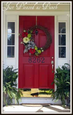 a red front door with a wreath on it