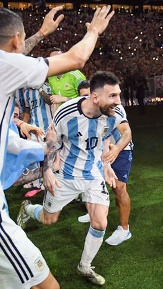 the soccer players are celebrating their team's win in front of an excited crowd