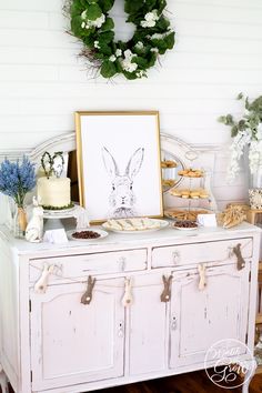 an old dresser is decorated with fresh flowers and greenery for the easter bunny party