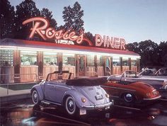 two cars parked in front of a diner