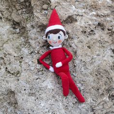 a crocheted elf doll laying on the ground