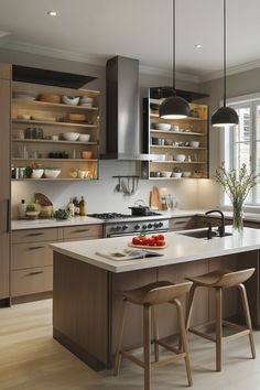 a kitchen with two stools next to an island