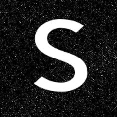 the letter s is written in white on a black background with small speckles