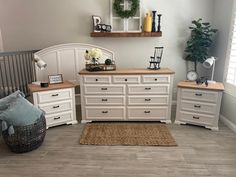 a white dresser sitting next to a bed in a bedroom