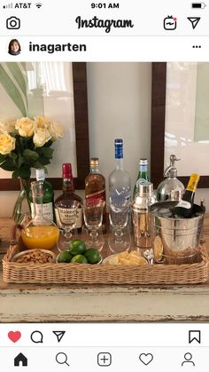 a wicker basket filled with liquor bottles and other alcohol on top of a table