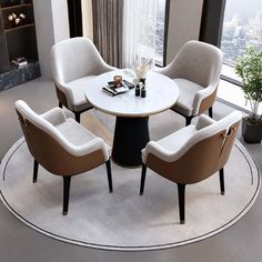 a round table with four chairs and a vase on it in front of a window