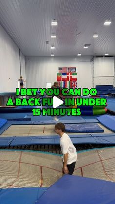 a young boy is playing on an inflatable trampoline at the gym