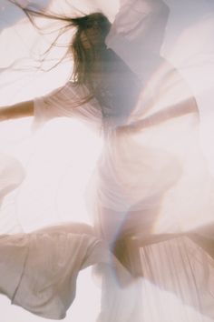 a woman in white dress flying through the air