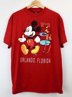 a red shirt with mickey mouse on it