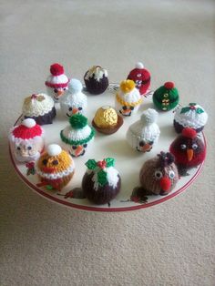 an assortment of knitted christmas ornaments on a plate