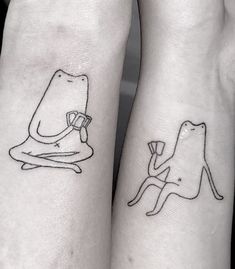 two people with matching tattoos on their arms, one has a dog and the other has a cat