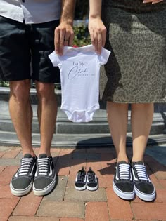 two people standing next to each other with shoes on their feet