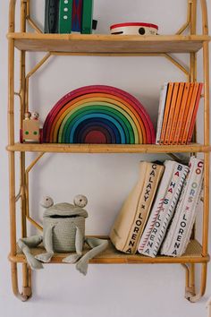 a bamboo shelf with books and toys on it