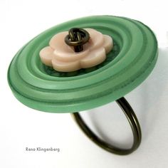 a green ring with a flower on it