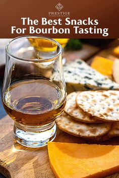 the best snacks for bourbon tasting are crackers, cheese, and honey on a cutting board