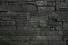 a black stone wall that is very dark