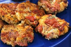 some crab cakes are on a blue plate