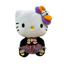 a hello kitty stuffed animal sitting on top of a white surface