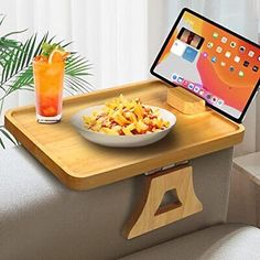 a tray with a bowl of food and an ipad on it