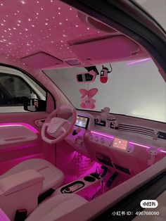 the interior of a car with pink lighting