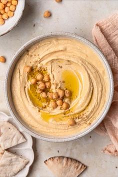 hummus in a bowl with pita bread on the side