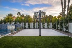 a backyard with a basketball hoop and pool