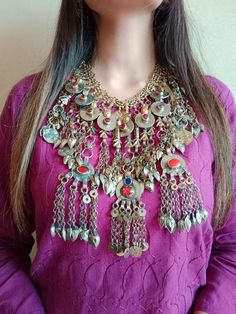 *Embrace the essence of traditional Afghani craftsmanship with this exquisite traditionally rich mala necklace, adorned with glass stones, tribal coins, fish motifs and tassels for a stunning effect. The long dangling layers exude the timeless charm of Afghani culture, a hallmark of the Kuchi tribe's heritage spanning centuries.  *Each layer boasts intricate embellishments, meticulously crafted to perfection. Fashioned from premium metal alloy and finished with rustic silver tones, this classic Bohemian Jewelry For Traditional Ceremonies, Artisan Necklaces For Traditional Ceremonies And Festivals, Traditional Coin Necklace For Festivals, Multicolor Bohemian Jewelry For Traditional Ceremonies, Traditional Coin Pendant Necklace For Festivals, Traditional Coin Necklace For Festivals And Gifts, Festival Amulet Necklace With Coin Pendant, Handmade Bohemian Necklaces For Traditional Ceremonies, Traditional Metal Necklaces For Festivals