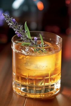 a close up of a drink on a table with a plant in the middle of it