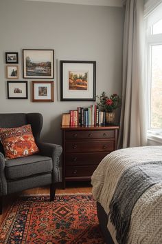 a bed room with a neatly made bed next to a chair and a large window