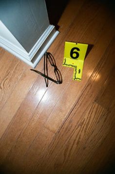 there is a yellow sign on the floor next to an open door and a pair of scissors