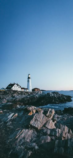 a light house sitting on top of a rocky shore